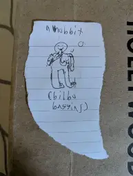 a scrap of paper with a bad drawing of a hobbit, labeled "(Bilbo Baggins)"