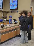 A literal child taking orders in a fast food restaurant in the US