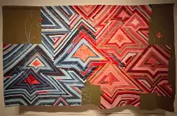 Woven wool in intricate diamond patterns with the Starship Enterprise stitched over the diamond patterns