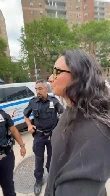 Four NYPD officers converged on one woman on a bike because she smiled at them, then detained her because she wasn't carrying ID.