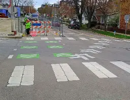 The 7-Line looking west from Dunn St. The cycle path is closed for construction and lane markers show that cyclists are supposed to cross diagonally in front of east, west, and southbound traffic.