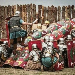 Re-enactors in full kit showing use of a 1st-2nd century AD Roman Testudo formation to allow troops to mount a wall