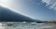 A rare atmospheric roll cloud, often mistaken for a tsunami, mesmerized beachgoers along Portugal’s shores