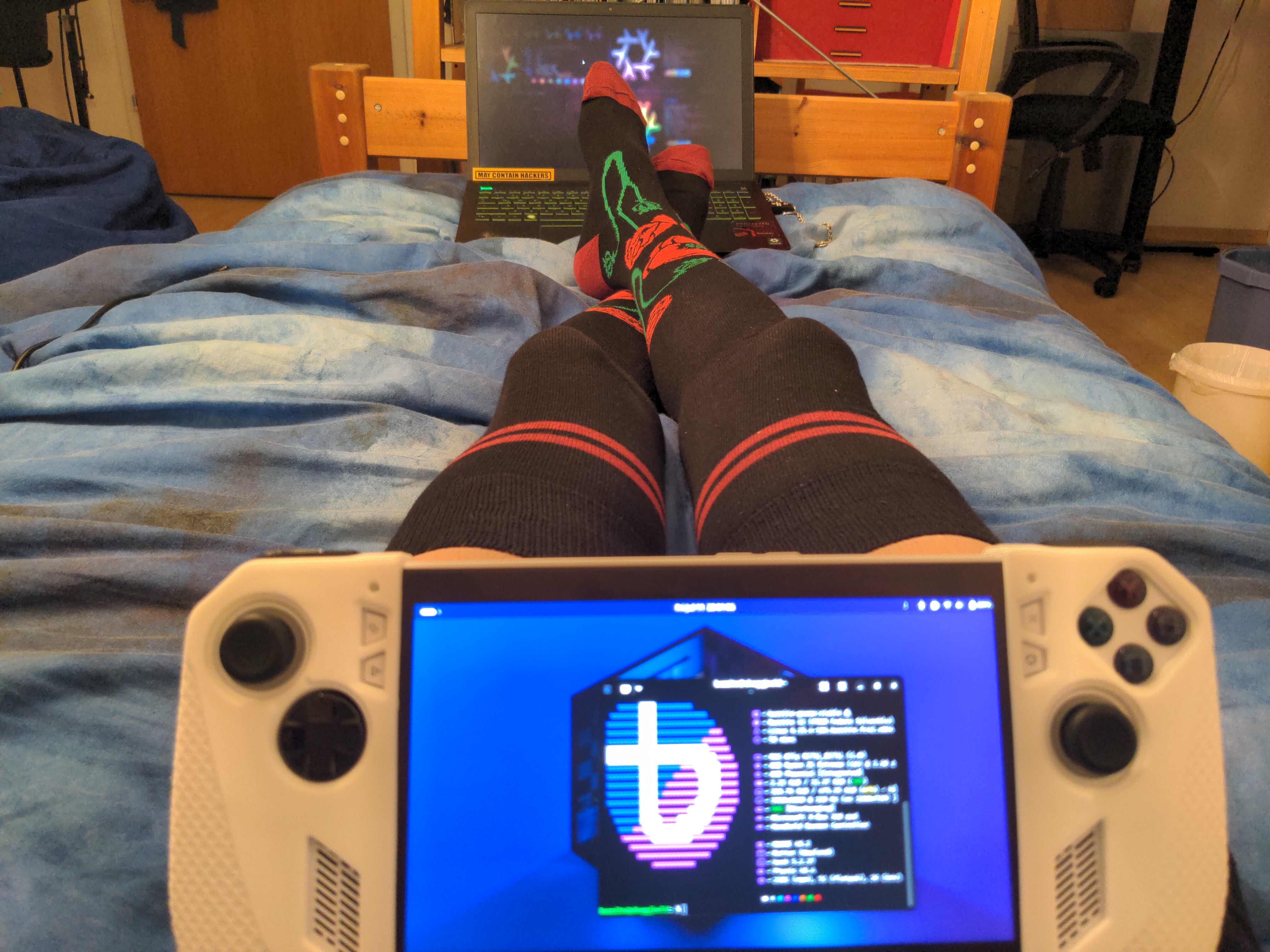 The same image as above but the gaming handheld is not laying flat anymore (!?)