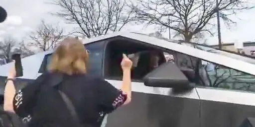 Elon Musk calls for 'arrests' after woman points her finger at a Cybertruck